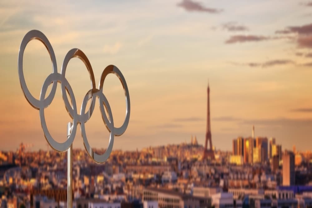 Olympic rings at sunset with the Eiffel tower in Paris, France